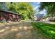 The spacious backyard features a shed and a view of the home's exterior and deck at 411 E Green St, Franklinton, NC 27525