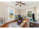 Sunlit bedroom features hardwood floors, rocking chair, and large windows offering a bright and airy space at 411 E Green St, Franklinton, NC 27525