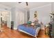 Cozy bedroom features wood floors, and a bed covered in colorful stuffed animals and comforters at 411 E Green St, Franklinton, NC 27525