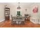 Bright dining room featuring hardwood floors, a modern table set, and decorative lighting at 411 E Green St, Franklinton, NC 27525