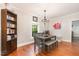 Inviting dining room featuring hardwood floors, a chandelier, and a bookshelf at 411 E Green St, Franklinton, NC 27525