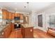 Spacious kitchen with stainless steel appliances, granite counters, wood cabinets, and a center island for extra workspace at 411 E Green St, Franklinton, NC 27525