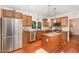 Well-lit kitchen features stainless steel appliances, granite countertops, wooden cabinets, and a convenient center island at 411 E Green St, Franklinton, NC 27525