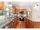 Kitchen area with granite countertops, stainless steel appliances, wooden cabinets, and a modern chrome sink at 411 E Green St, Franklinton, NC 27525