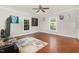 Bright living room with hardwood floors, natural lighting, and neutral wall colors at 411 E Green St, Franklinton, NC 27525