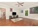 Bright living room with hardwood floors, a ceiling fan, and neutral wall colors at 411 E Green St, Franklinton, NC 27525