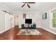 Spacious living room featuring hardwood floors, natural lighting, and access to other rooms at 411 E Green St, Franklinton, NC 27525