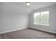 This is a bedroom with neutral paint and carpet with a double window providing natural light at 422 Grading Stick Ct, Angier, NC 27501