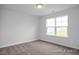 This bedroom features carpeted floors, light and bright walls, and a large window at 422 Grading Stick Ct, Angier, NC 27501