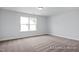 This bedroom features carpeted floors, light and bright walls, and a large window at 422 Grading Stick Ct, Angier, NC 27501