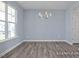 Well-lit dining area with wood-look floors and a stylish chandelier at 422 Grading Stick Ct, Angier, NC 27501
