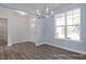 Inviting dining space featuring light blue walls, wood-look floors, and a modern chandelier at 422 Grading Stick Ct, Angier, NC 27501