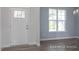 Bright entryway showcasing wood-look flooring, white trim, and a window-lit view of the outdoors at 422 Grading Stick Ct, Angier, NC 27501