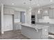 Spacious kitchen with gray cabinets, granite countertops, and stainless steel appliances at 422 Grading Stick Ct, Angier, NC 27501