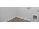 Clean laundry area featuring light gray walls, white trim, and wood-look flooring at 422 Grading Stick Ct, Angier, NC 27501