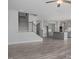 Open-concept living space with wood-look flooring, a staircase, and an open kitchen at 422 Grading Stick Ct, Angier, NC 27501