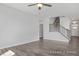 Bright living room with hardwood floors and staircase with metal spindles leading to the second floor at 422 Grading Stick Ct, Angier, NC 27501