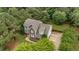 Aerial shot of a two-story home with mature trees, concrete driveway, and fenced backyard at 50 Pebble Creek Dr, Franklinton, NC 27525
