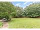 Expansive backyard with lush green grass and mature trees, perfect for outdoor activities at 50 Pebble Creek Dr, Franklinton, NC 27525