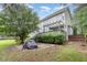 Exterior view of a charming home featuring a back deck, patio area and mature landscaping at 50 Pebble Creek Dr, Franklinton, NC 27525