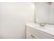 This full bathroom features a single sink, a full mirror, and updated fixtures at 50 Pebble Creek Dr, Franklinton, NC 27525