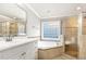 This is an updated bathroom featuring dual sinks, a tub, and a standup shower at 50 Pebble Creek Dr, Franklinton, NC 27525