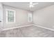 This is an empty bedroom with carpet flooring, two windows, and neutral colored walls at 50 Pebble Creek Dr, Franklinton, NC 27525
