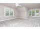 Bright bedroom featuring neutral walls, plush carpet, and natural light from large windows at 50 Pebble Creek Dr, Franklinton, NC 27525