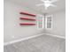 This bedroom features neutral walls, plush carpet, and eye-catching shelves for storage and decor at 50 Pebble Creek Dr, Franklinton, NC 27525