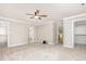 This is an empty bedroom with carpet flooring, three doors, and neutral colored walls at 50 Pebble Creek Dr, Franklinton, NC 27525