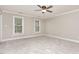 This is an empty bedroom with carpet flooring, two windows, and neutral colored walls at 50 Pebble Creek Dr, Franklinton, NC 27525