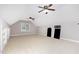 Spacious bonus room with ample lighting, carpeted flooring, and versatile built-in shelving at 50 Pebble Creek Dr, Franklinton, NC 27525