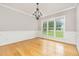 Elegant dining room with a decorative chandelier, wainscoting, and large windows offering great views at 50 Pebble Creek Dr, Franklinton, NC 27525