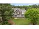 Beautiful two-story home with stone and siding exterior, complemented by lush greenery at 50 Pebble Creek Dr, Franklinton, NC 27525