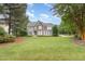 Beautiful two-story home with stone accents, a well-manicured lawn, and mature trees enhancing its curb appeal at 50 Pebble Creek Dr, Franklinton, NC 27525