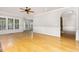 Open-concept living room featuring hardwood floors, arched doorways, and large windows, with abundant natural light at 50 Pebble Creek Dr, Franklinton, NC 27525