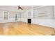 Inviting living room with wood floors, fireplace, built-in shelving, and windows providing natural light at 50 Pebble Creek Dr, Franklinton, NC 27525