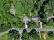 This is an aerial shot of a home in a community surrounded by many trees and some grass at 5121 Ten Point Trl, Wake Forest, NC 27587