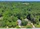 An aerial view of a home surrounded by lush greenery and trees, set within a sprawling neighborhood at 5121 Ten Point Trl, Wake Forest, NC 27587