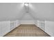 Finished attic space with carpet, lighting, and built-in shelves at 5121 Ten Point Trl, Wake Forest, NC 27587