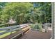 Spacious back deck with seating overlooks lush landscaping at 5121 Ten Point Trl, Wake Forest, NC 27587