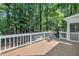 Back deck with railing surrounded by forest at 5121 Ten Point Trl, Wake Forest, NC 27587
