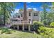 The back exterior view highlights the home's architectural details, chimney, and lovely backyard at 5121 Ten Point Trl, Wake Forest, NC 27587