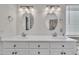 Bathroom with double sinks with sleek faucets and dark hardware at 5121 Ten Point Trl, Wake Forest, NC 27587
