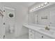 Well lit bathroom vanity area with marble countertops and octagon window into water closet at 5121 Ten Point Trl, Wake Forest, NC 27587
