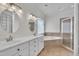 Bright bathroom featuring double sinks, soaking tub, and walk-in shower with glass door at 5121 Ten Point Trl, Wake Forest, NC 27587