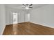 Spacious bedroom with hardwood floors and an ensuite bathroom behind double doors at 5121 Ten Point Trl, Wake Forest, NC 27587