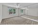 Carpeted bedroom featuring a ceiling fan and large windows for natural light at 5121 Ten Point Trl, Wake Forest, NC 27587