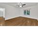 Bright bedroom featuring hardwood floors, ceiling fan, and a large window at 5121 Ten Point Trl, Wake Forest, NC 27587