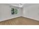 Bright bedroom features a ceiling fan, beautiful floors, and a large window at 5121 Ten Point Trl, Wake Forest, NC 27587